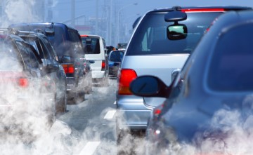 exhaust from cars along a highway